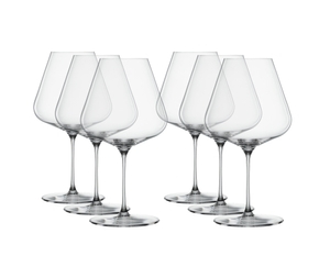 SPIEGELAU Definition Burgundy Glass filled with a drink on a white background