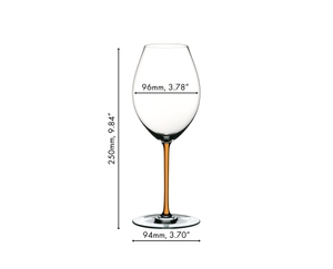 A RIEDEL Fatto A Mano Syrah glass in orange filled with red wine on a white background. 