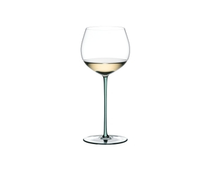 A RIEDEL Fatto A Mano Oaked Chardonnay glass in mint filled with white wine on a transparent background. 