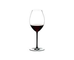 A RIEDEL Fatto A Mano Syrah glass in black filled with red wine on a transparent background. 