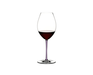 A RIEDEL Fatto A Mano Syrah glass in violet filled with violet wine on a transparent background. 