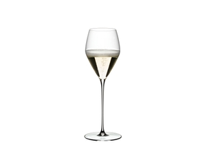 RIEDEL Veloce Champagne Wine Glass filled with a drink on a white background