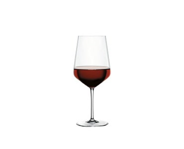 SPIEGELAU Style Red Wine Glass filled with a drink on a white background