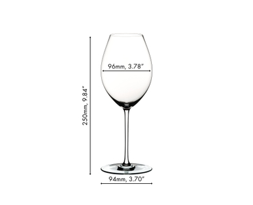 A RIEDEL Fatto A Mano Syrah glass in white filled with red wine on a white background. 