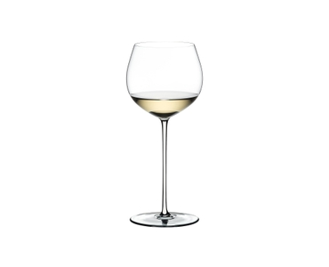 A RIEDEL Fatto A Mano Oaked Chardonnay glass in white filled with white wine on a transparent background. 