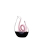RIEDEL Curly Decanter - pink filled with a drink on a white background