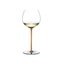 A RIEDEL Fatto A Mano Oaked Chardonnay glass in orange filled with white wine on a transparent background. 