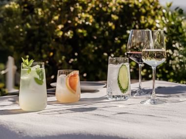 SPIEGELAU Capri long drink glass, tumbler, white wine glass and red wine glass on a table in the garden