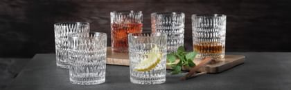 various tumblers lined up with black background