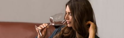Woman holding red wine glass