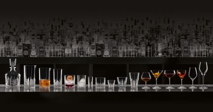 various glassware lined up on a bar