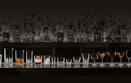 various glassware lined up on a bar