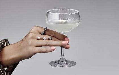 A woman's hand holding the Spiegelau Perfect Serve Collection Coupette filled with a Margarita.
