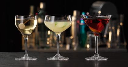 The SPIEGELAU Perfect Serve Collection cocktail glasses, all filled with specific cocktails. The Perfect Nick and Nora glass is on the left, followed by the Perfect Coupette glass and the Perfect Cocktail glass on the right side.<br/>