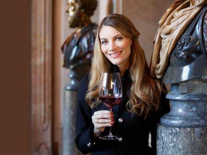 woman holding red wine glass