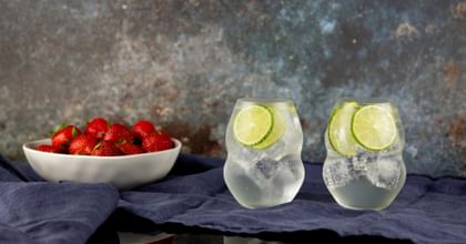gin and tonics in RIEDEL glassware next to strawberries