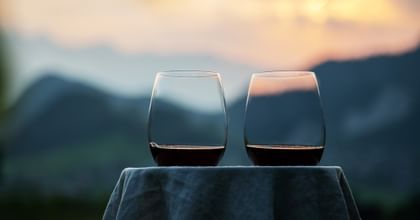 stemless red wine glasses with mountain sunset background
