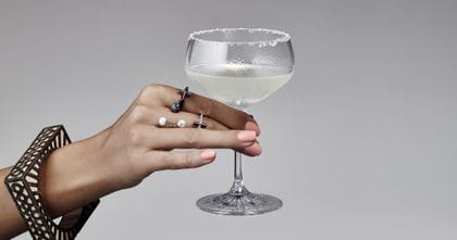 A woman's hand holding the Spiegelau Perfect Serve Collection Coupette filled with a Margarita.