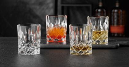 NACHTMANN Noblesse tumblers, one of them filled with Whisky. Two are filled with drinks on ice and one is empty.<br/>