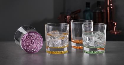 various bar glasses and barware on table
