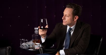 Maximilian Riedelwith a Riedel SL Winewings glass filled with red wine