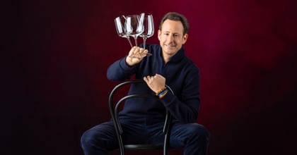 Maximilian J. Riedel holding GRAPE@RIEDEL glasses