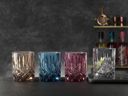 The NACHTMANN Noblesse whiskey tumblers in the vintage colors tobacco, vintage blue, berry and smoke in a row.<br/>