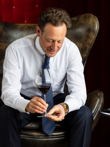 man holding wine glass