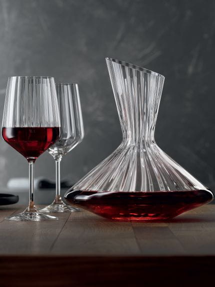 Spiegelau Lifestyle Decanter set filled with red wine on wooden bench.