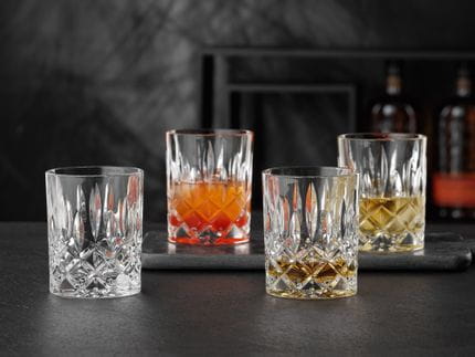 NACHTMANN Noblesse tumblers, one of them filled with Whisky. Two are filled with drinks on ice and one is empty.<br/>